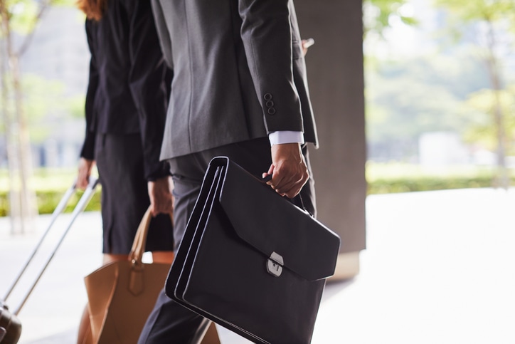 Business Travel detail of briefcase and suitcase.